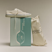 Men's Founders Edition Yacht Shoe in White canvas, pair resting on a mint green shoe box beside a cotton drawstring bag