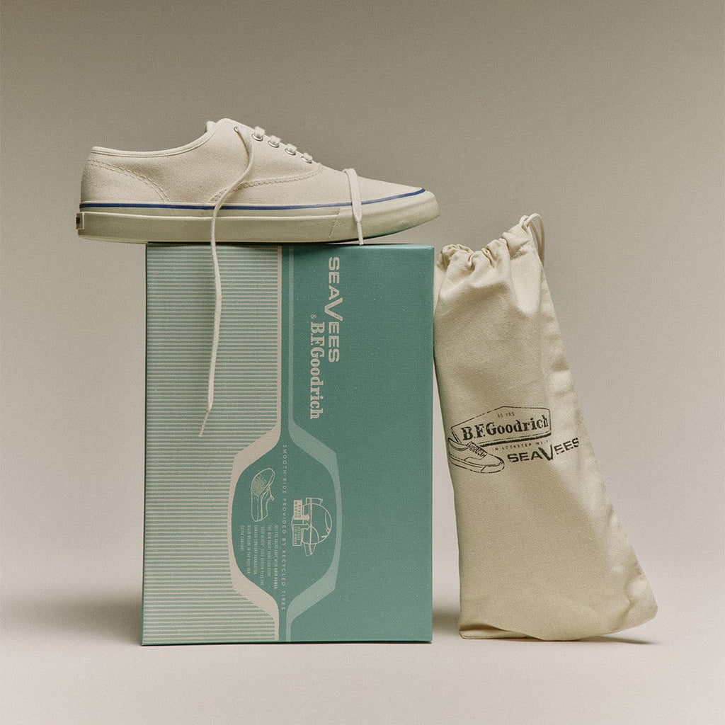 Men's Founders Edition Yacht Shoe in White canvas, pair resting on a mint green shoe box beside a cotton drawstring bag