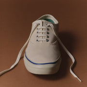 Men's Founders Edition Yacht Shoe in White canvas, front view with white laces on a brown background
