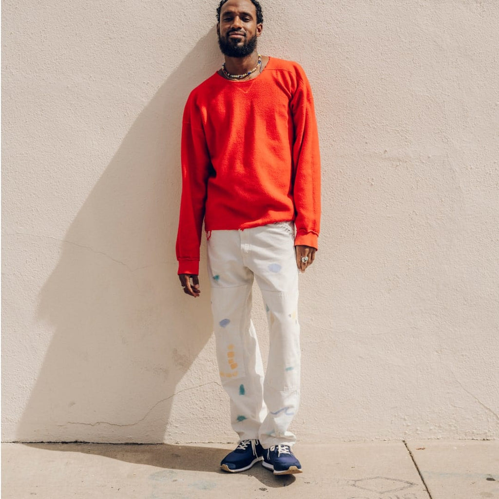 Men's Royal Runner sneaker in Blue nylon and suede, worn with white pants and a red sweatshirt, full-length view