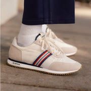 Men's Royal Runner sneaker in White nylon and suede, close-up worn with white socks, stripe detail visible, on pavement