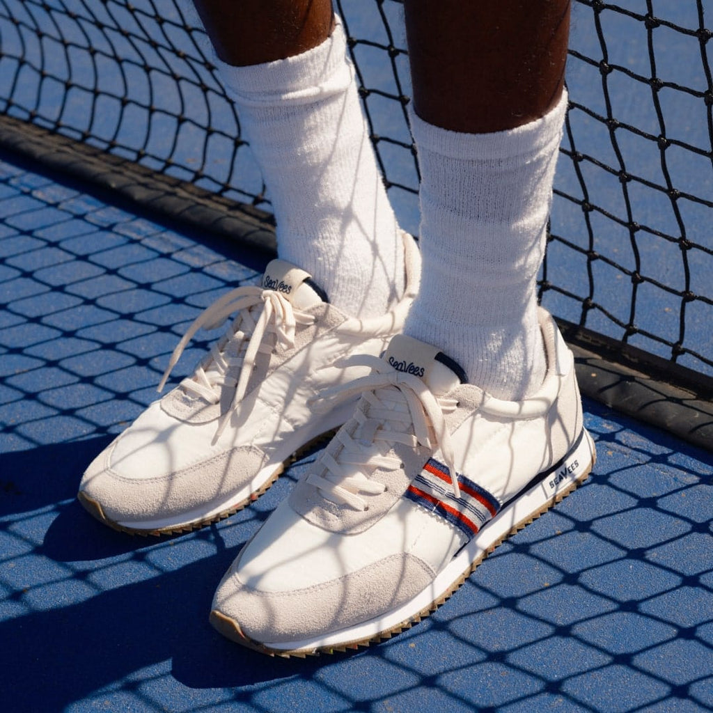 Men's Royal Runner sneaker in White nylon and suede, close-up worn with white socks on a tennis court