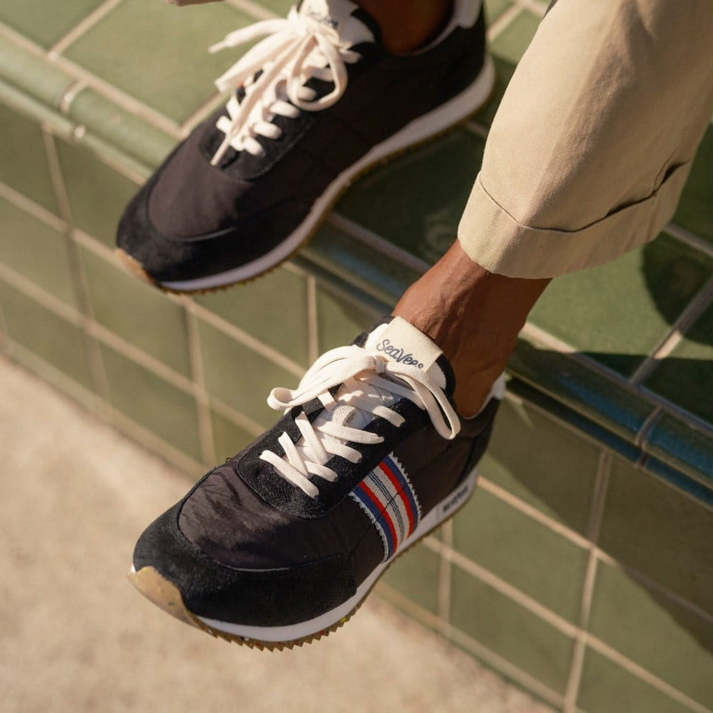 Men's Royal Runner sneaker in Black nylon and suede, close-up with laces and stripe detail, worn