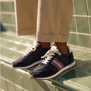 Men's Royal Runner sneaker in Black nylon and suede, worn with khaki pants on green tile