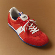 Women's Parsons Low Profile Trainer sneaker in Ribbon Red nylon and suede, angled view with white laces on a brown background