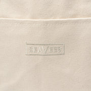 Close up of the embossed SeaVees logo on a natural canvas tote bag