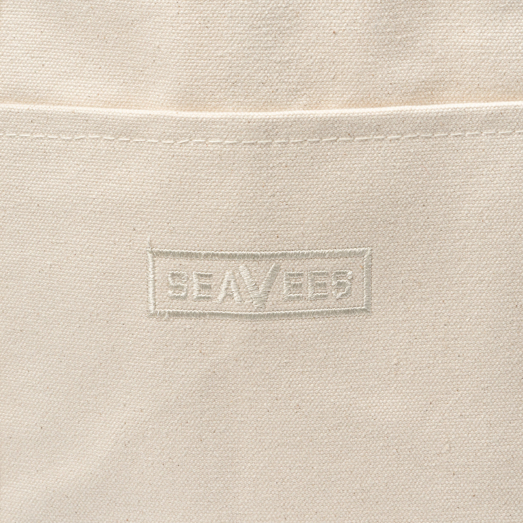 Close up of the embossed SeaVees logo on a natural canvas tote bag