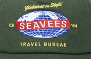 Close up of the SeaVees Travel Bureau globe patch on a green hat