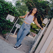 Women's Melrose Lug Platform in Black canvas, worn with wide jeans and a striped top, full-length view outdoors