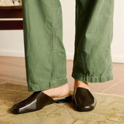 Women's Sadie Slide in Dark Chocolate rubber, worn with olive pants, side view