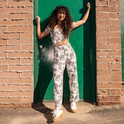 Women's SeaChange LTT sneaker in White/Gum corn leather, worn with printed pants, full-length view in front of a green door
