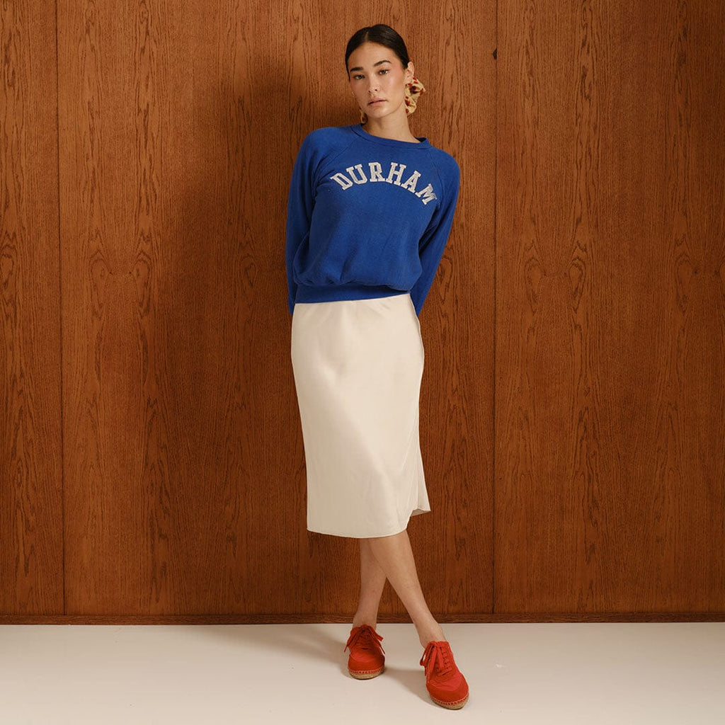 Women's Avenue Espadrille in Strawberry nylon and suede, worn by a person in a blue sweatshirt and cream skirt