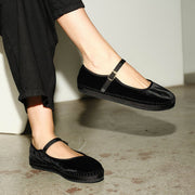 Women's Carlyle Mary Jane in Black velvet, worn with black pants, one foot raised