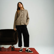 Women's Diamond Cup sneaker in Black leather, worn by a woman standing on a red rug