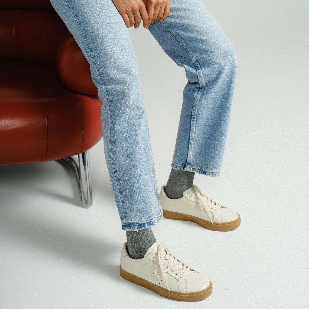Women's Diamond Cup sneaker in Ecru leather, ecru pair worn with light jeans, side view