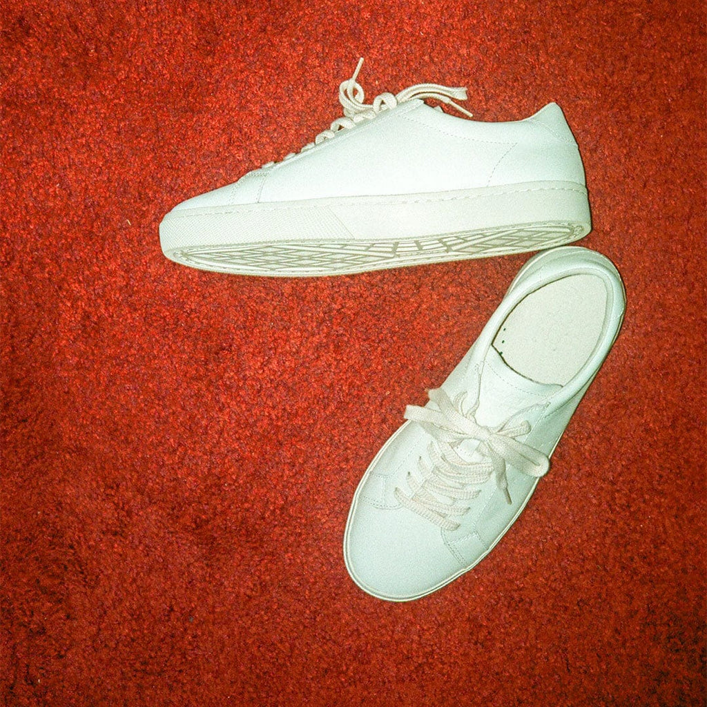 Women's Diamond Cup sneaker in White leather, pair on a red rug, top view