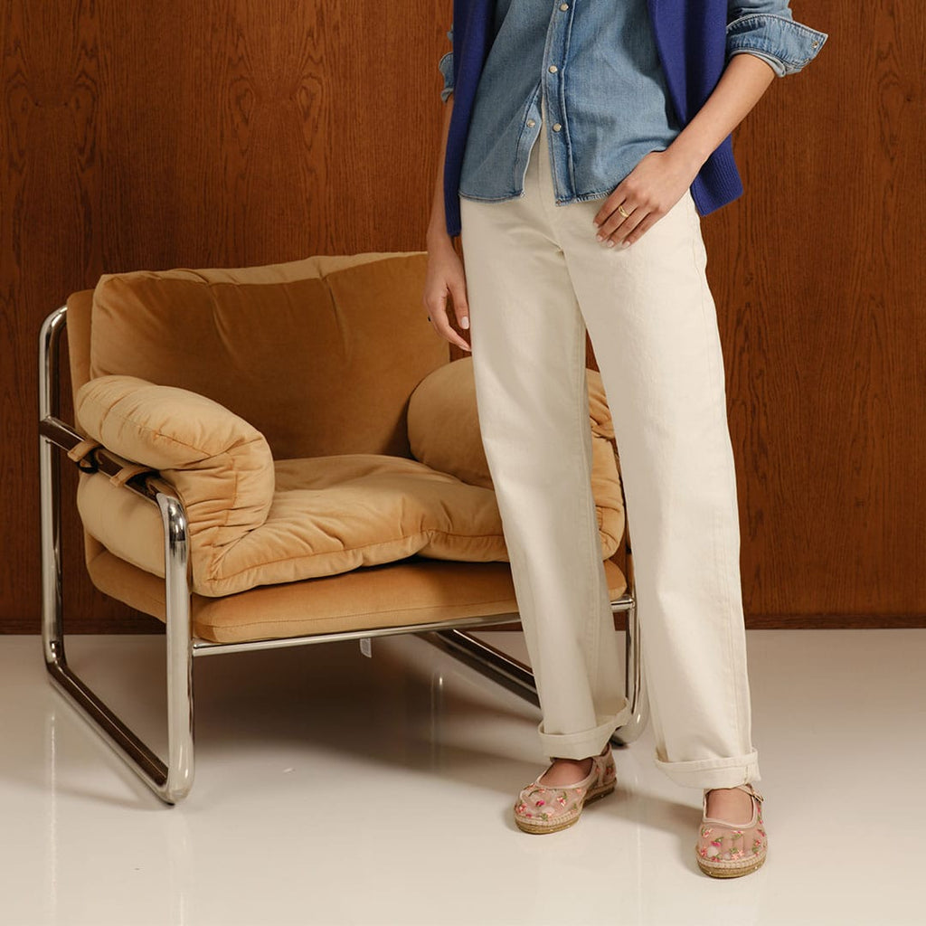 Women's Miramar Espadrille in Bloom mesh, worn by a person standing beside a leather chair in cream pants
