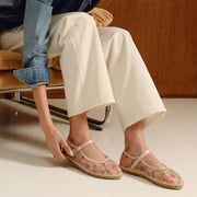 Women's Miramar Espadrille in Bloom mesh, worn with cuffed cream pants, seated on a leather chair