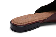 Women's Sadie Slide in Deep Cherry rubber, close-up of the heel showing the tan footbed and dark sole