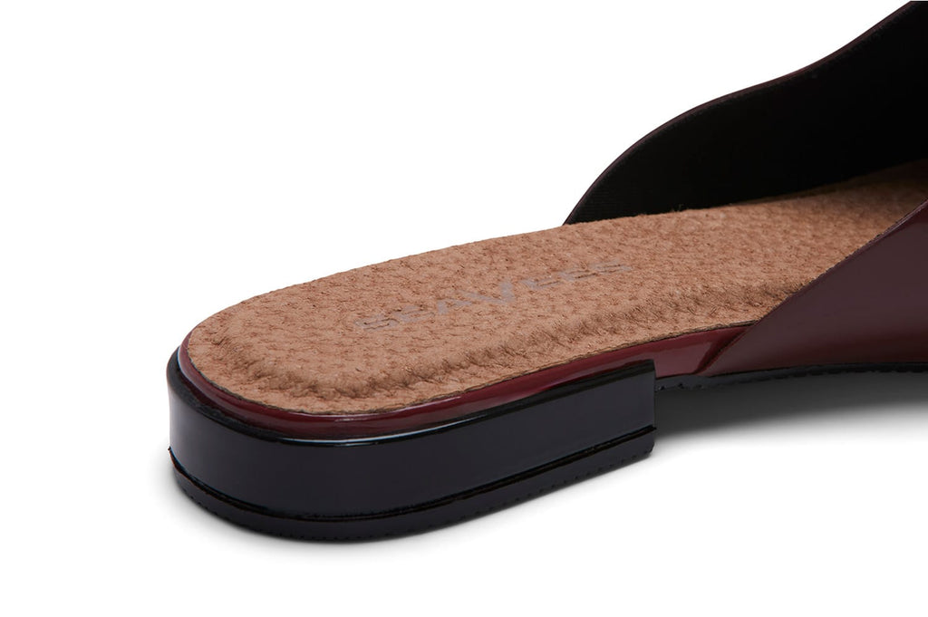 Women's Sadie Slide in Deep Cherry rubber, close-up of the heel showing the tan footbed and dark sole