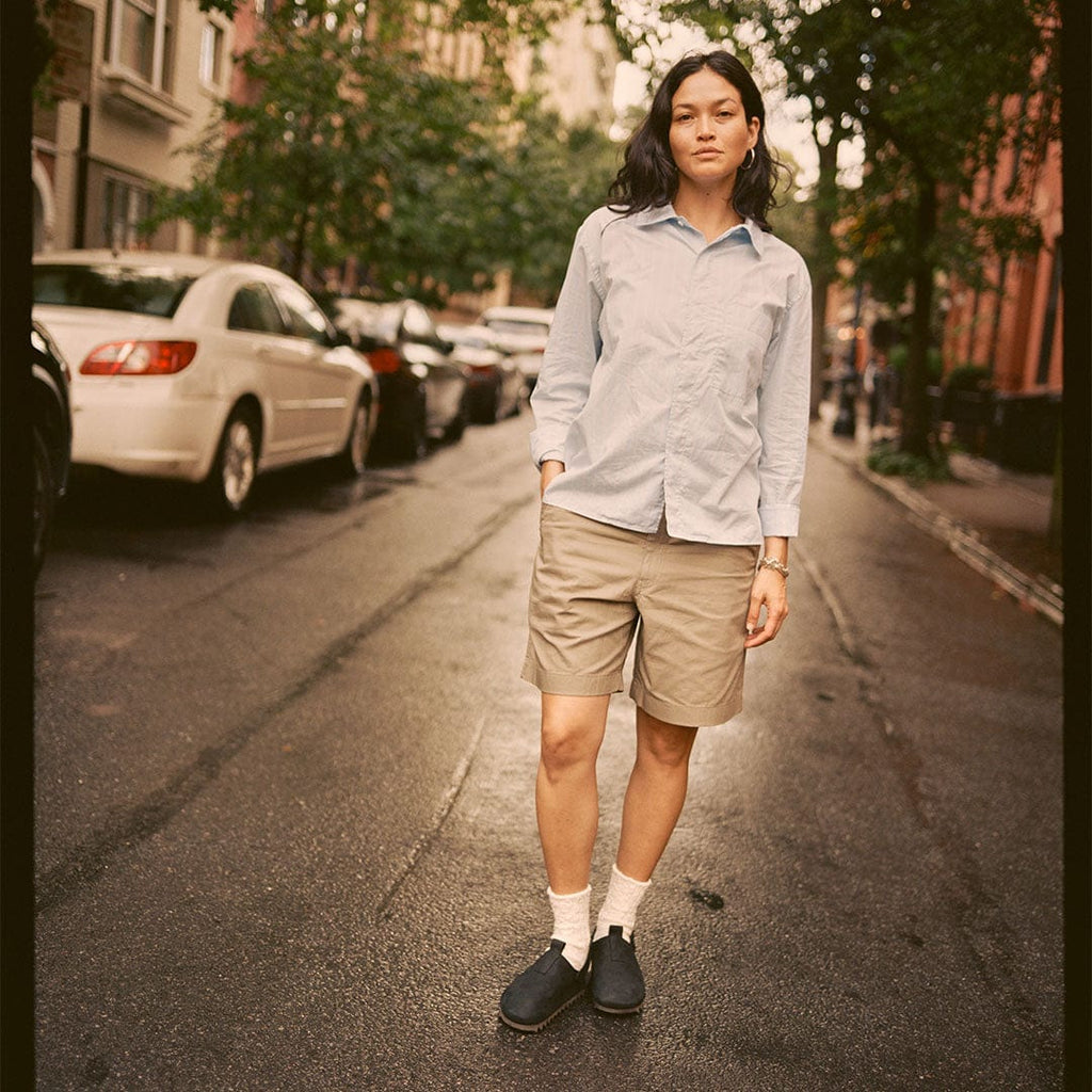 Women's Tahoe Trekker sandal in Black leather, worn by a person standing in khaki shorts on a city street