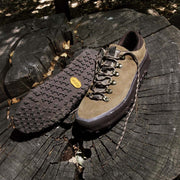 Men's Ridge Urban Hiker hiking sneaker in Desert Palm suede, pair on a tree stump, one showing the Vibram outsole