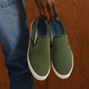 Men's Baja Slip On in Surplus Green vegan nubuck, held up in both hands showing the perforated upper and lining