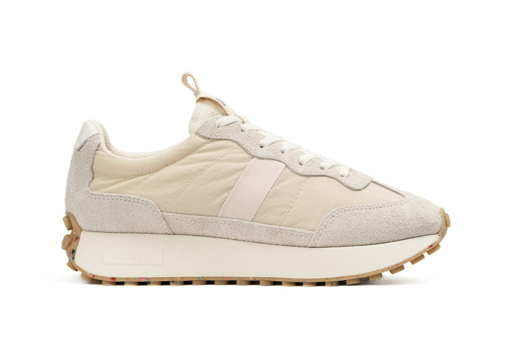 Side view of the Men's Acorn Trainer in the color Cloud against a white backdrop, showcasing the silhouette of the shoe.