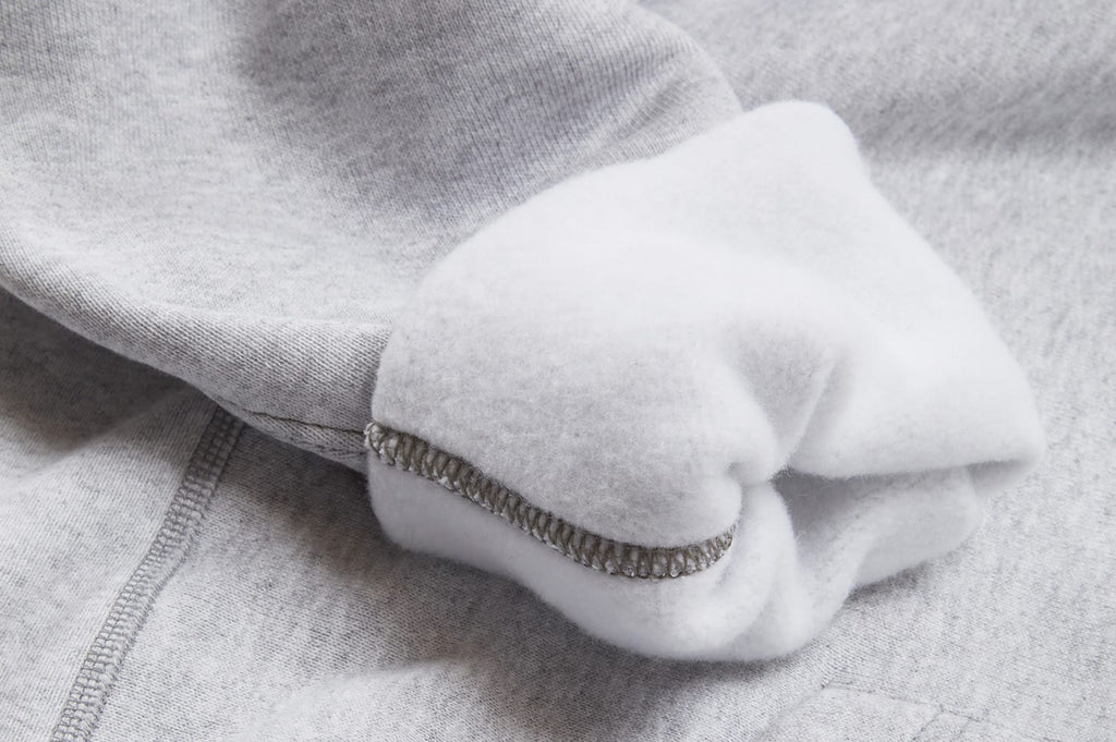 Close up of the ribbed cuff on a heather gray hoodie
