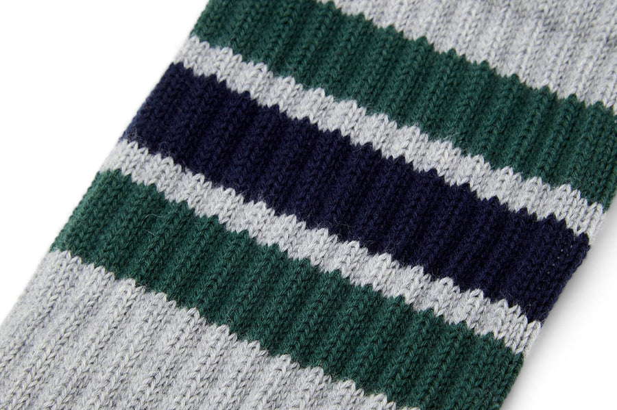 Close up of green and navy stripes on a heather gray crew sock