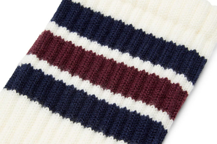 Close up of navy and burgundy stripes on an ivory crew sock