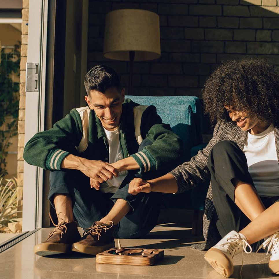 Men's Maslon Desert Boot in Kona leather, worn by two people seated in a doorway