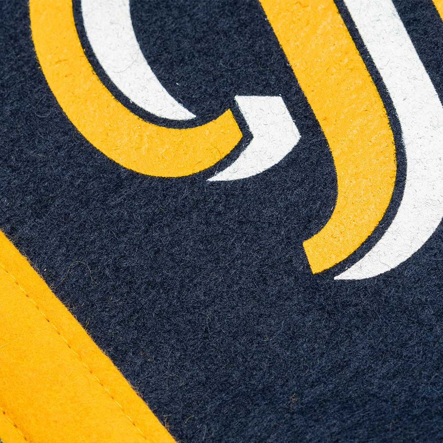 Close up of gold and white lettering on the navy camp flag