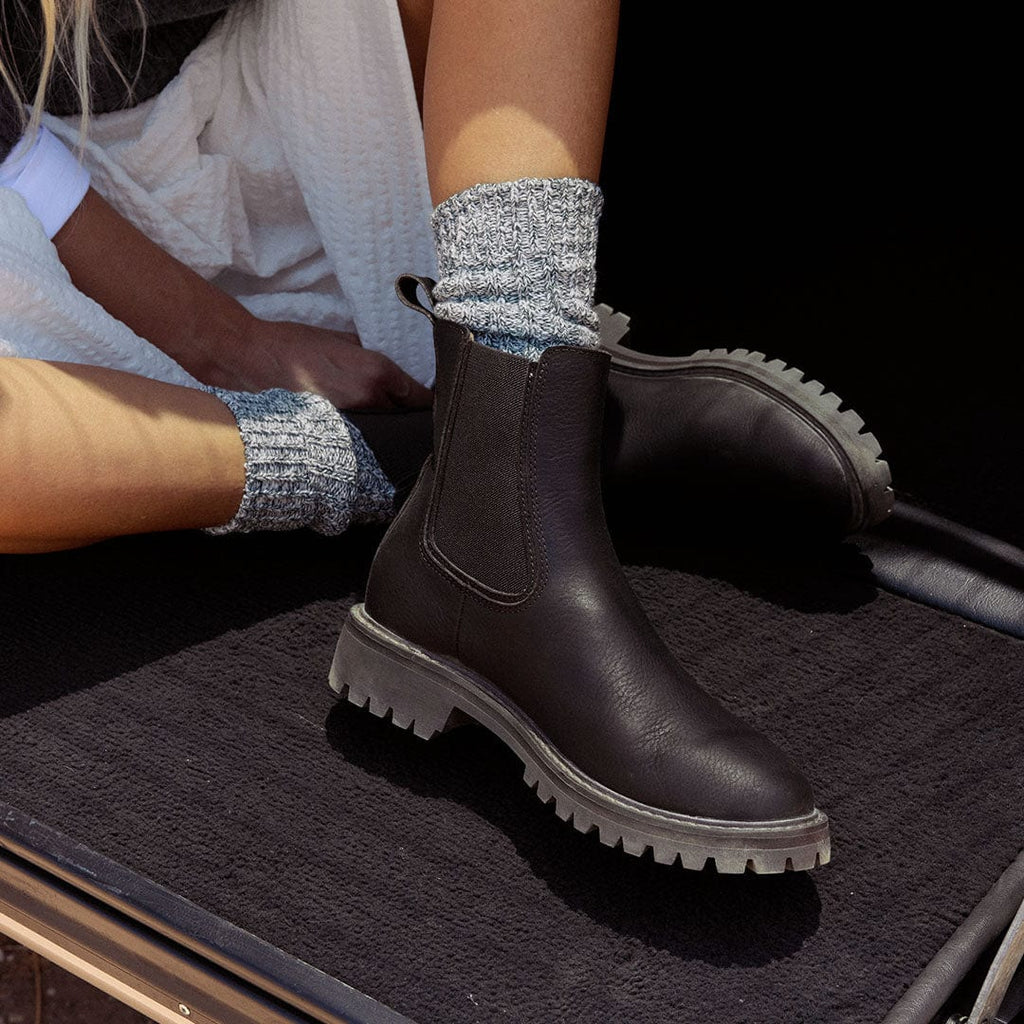 Women's Salt Creek Boot in Dark Chocolate leather, worn with speckled gray socks, close up of the lug sole