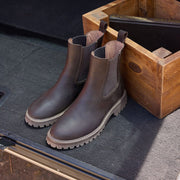 Women's Salt Creek Boot in Dark Chocolate leather, pair resting in an open wooden crate
