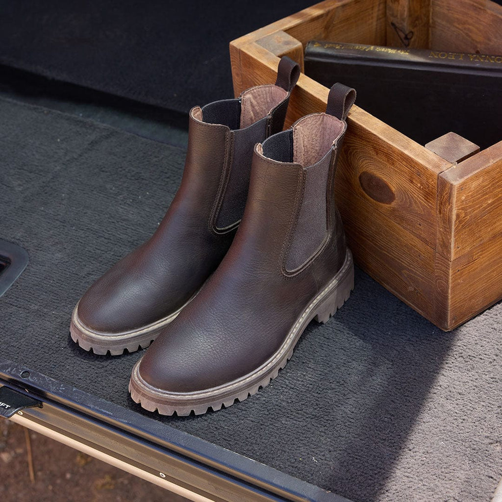 Women's Salt Creek Boot in Dark Chocolate leather, pair resting in an open wooden crate